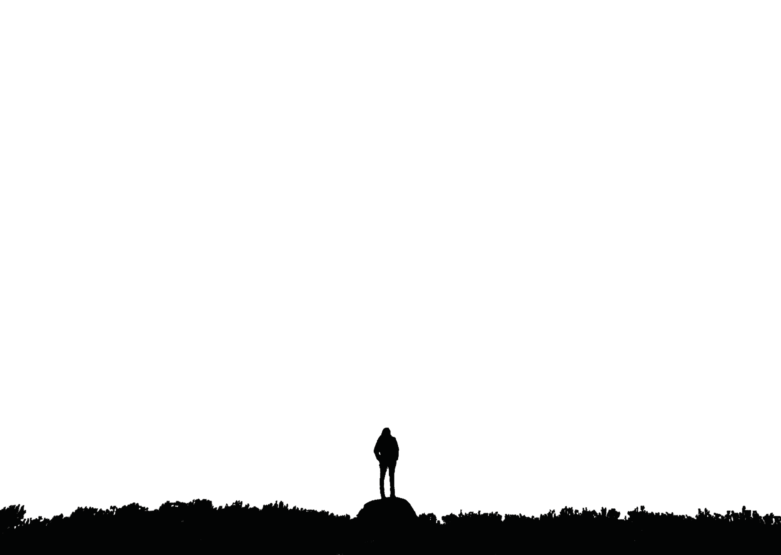 A lone explorer standing on a summit